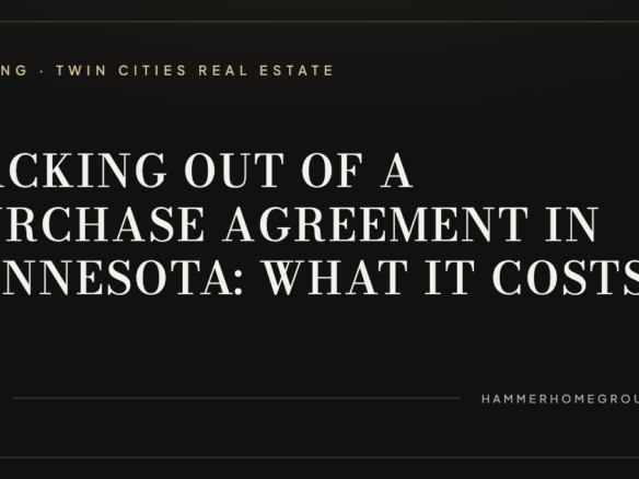 Signed purchase agreement in Minnesota with house keys and pen on a dark walnut desk