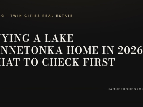 Private dock and boat lift on a calm Lake Minnetonka shoreline at dusk in front of a luxury lakefront home