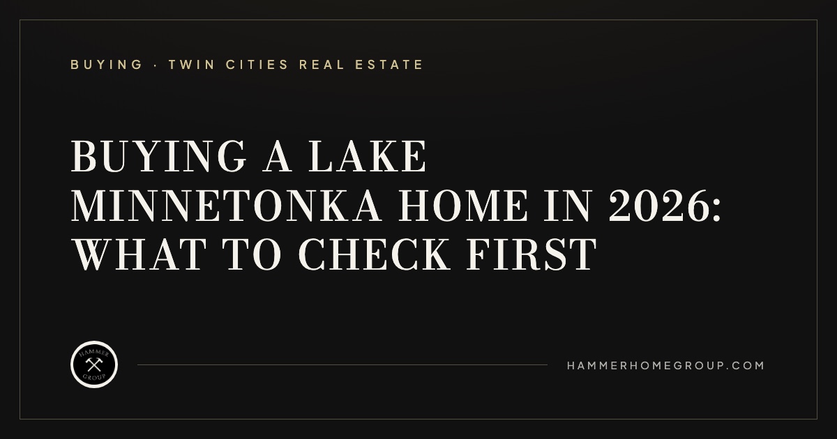 Private dock and boat lift on a calm Lake Minnetonka shoreline at dusk in front of a luxury lakefront home